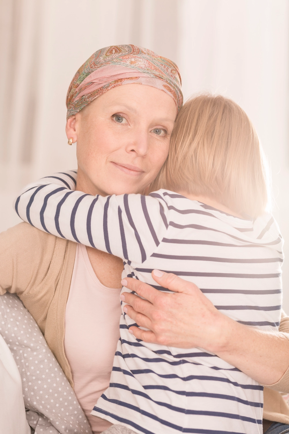 Mother with leukemia hugging child
